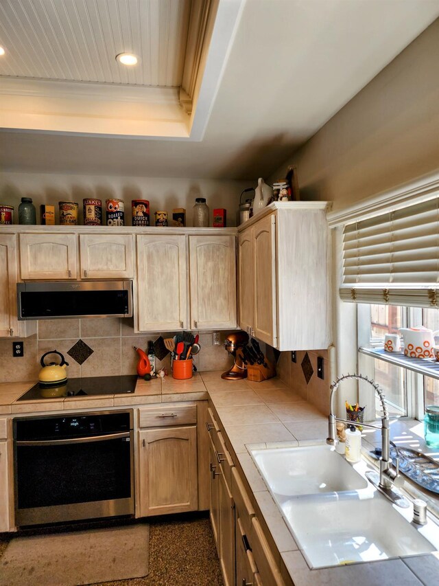 2513 Twain Ave, Clovis, CA 93611 - kitchen featuring stainless steel oven, tile counters, black electric stovetop, a sink, and recessed lighting