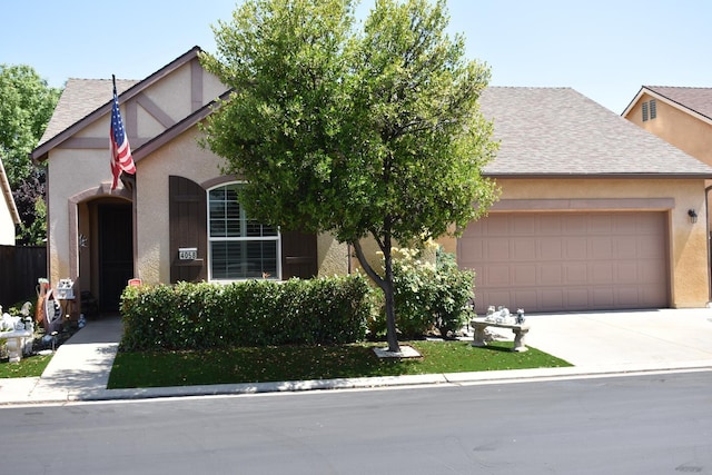 4058 Chessa Ln, Clovis, CA 93619 - view of front of property featuring an attached garage, roof with shingles, stucco siding, and driveway
