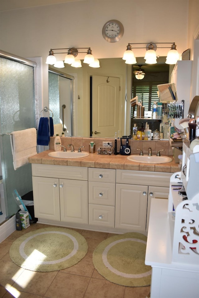 4058 Chessa Ln, Clovis, CA 93619 - full bathroom featuring a stall shower, double vanity, and tile patterned flooring