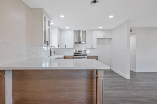 513 Waldo, Exeter, CA 93221 - kitchen featuring wall chimney range hood, stainless steel gas range, a sink, wood finished floors, and baseboards
