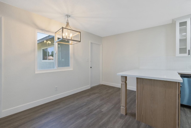 513 Waldo, Exeter, CA 93221 - unfurnished dining area with dark wood finished floors, a chandelier, and baseboards