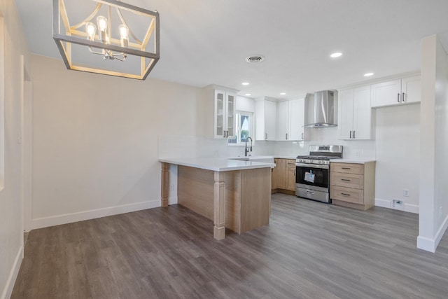 513 Waldo, Exeter, CA 93221 - kitchen featuring stainless steel range with gas stovetop, wall chimney range hood, a peninsula, baseboards, and recessed lighting