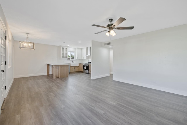 513 Waldo, Exeter, CA 93221 - unfurnished living room featuring baseboards, light wood-style flooring, a chandelier, ceiling fan, and recessed lighting