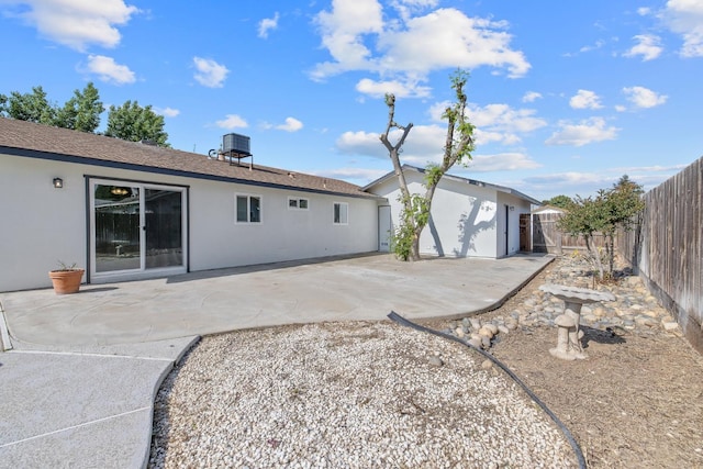 513 Waldo, Exeter, CA 93221 - back of house featuring stucco siding, a patio area, a fenced backyard, central air condition unit, and roof with shingles