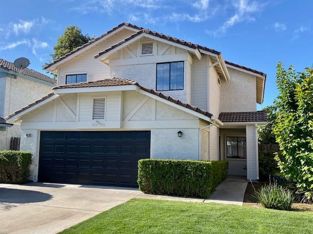 485 E Alluvial Ave Unit 102, Fresno, CA 93720 - traditional-style home with a tile roof, concrete driveway, an attached garage, and stucco siding