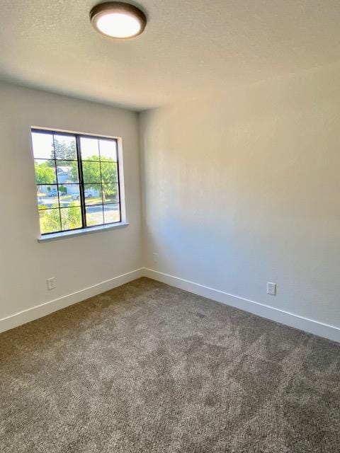 485 E Alluvial Ave Unit 102, Fresno, CA 93720 - empty room featuring dark colored carpet and baseboards