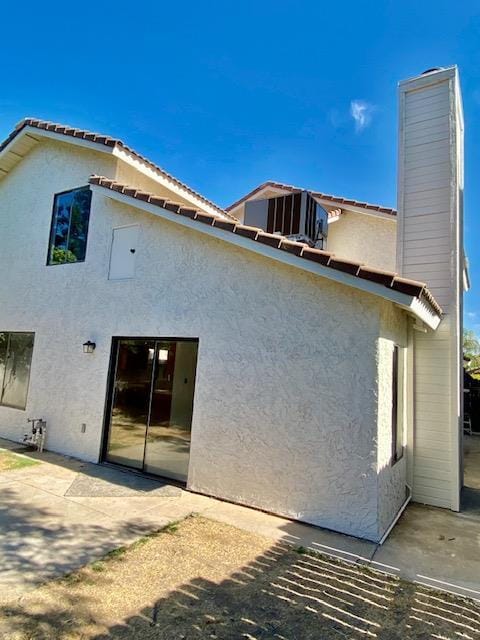 485 E Alluvial Ave Unit 102, Fresno, CA 93720 - rear view of house featuring a patio area, stucco siding, and a chimney