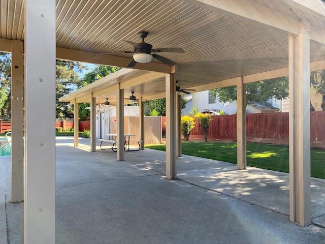 485 E Alluvial Ave Unit 102, Fresno, CA 93720 - fenced backyard featuring a ceiling fan and a patio area