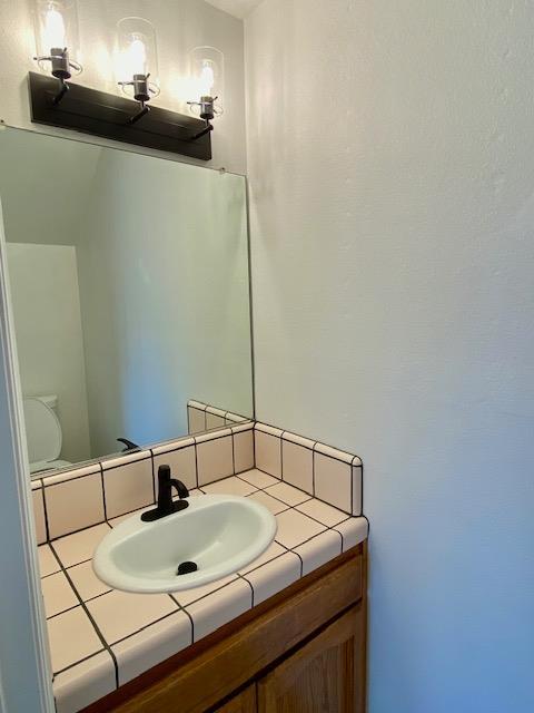 485 E Alluvial Ave Unit 102, Fresno, CA 93720 - half bathroom with vanity and toilet