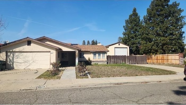6377 N Genoa Ave, Fresno, CA 93722 - single story home with an attached garage, stucco siding, driveway, and a tile roof