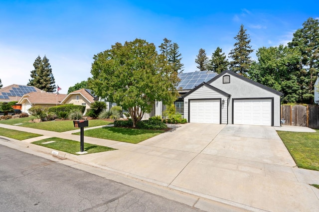 8814 N Spalding, Fresno, CA 93720 - ranch-style home featuring roof mounted solar panels, a garage, and driveway