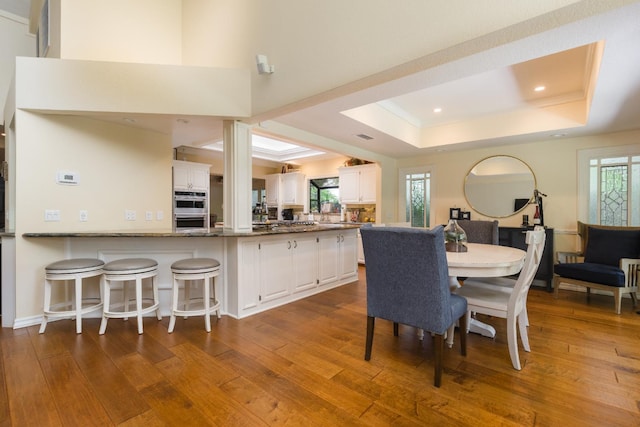 499 E Braddock Dr, Fresno, CA 93720 - dining area with a raised ceiling, hardwood / wood-style floors, plenty of natural light, and recessed lighting