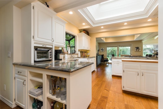499 E Braddock Dr, Fresno, CA 93720 - kitchen featuring white cabinetry, light wood-type flooring, a peninsula, a sink, and recessed lighting
