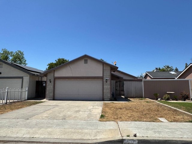 2761 N Selland, Fresno, CA 93722 - ranch-style home featuring a garage, concrete driveway, and a gate