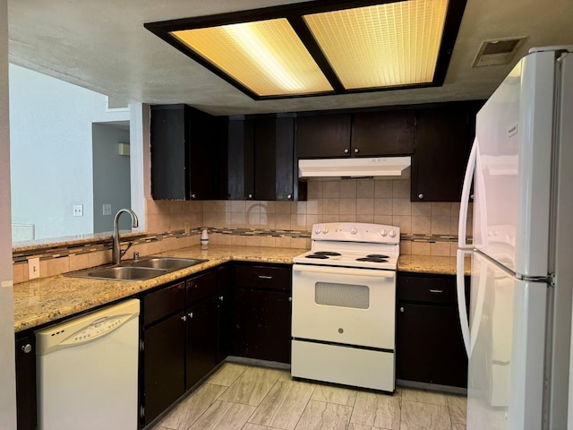 2761 N Selland, Fresno, CA 93722 - kitchen with white appliances, under cabinet range hood, a sink, and tasteful backsplash