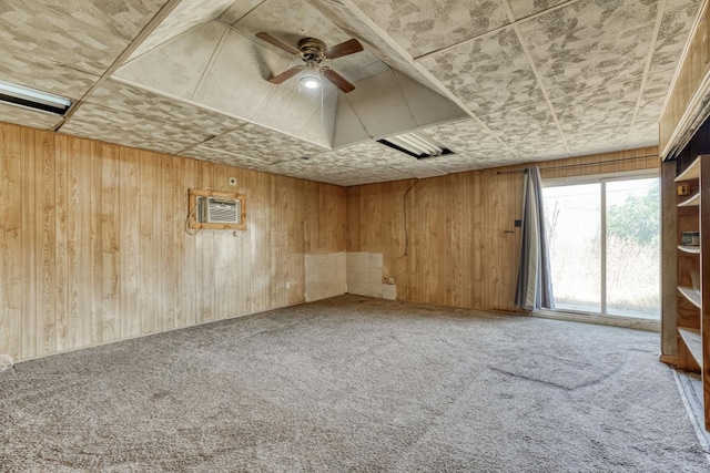 6298 N Glenn Ave, Fresno, CA 93704 - empty room with carpet, wooden walls, ceiling fan, and an AC wall unit