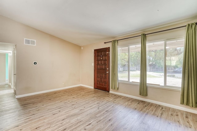 6298 N Glenn Ave, Fresno, CA 93704 - spare room featuring baseboards, light wood-style flooring, and vaulted ceiling