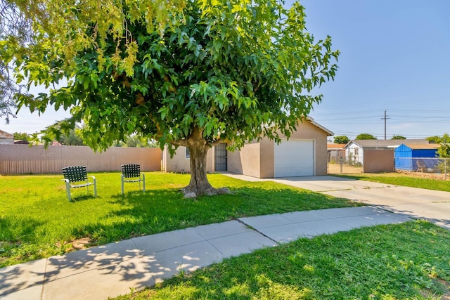829 W Woodward Ave, Fresno, CA 93706 - view of front facade with concrete driveway, a garage, and stucco siding