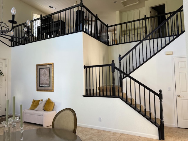 9130 Hunters Creek Way, Chowchilla, CA 93610 - staircase featuring a high ceiling, baseboards, and tile patterned floors
