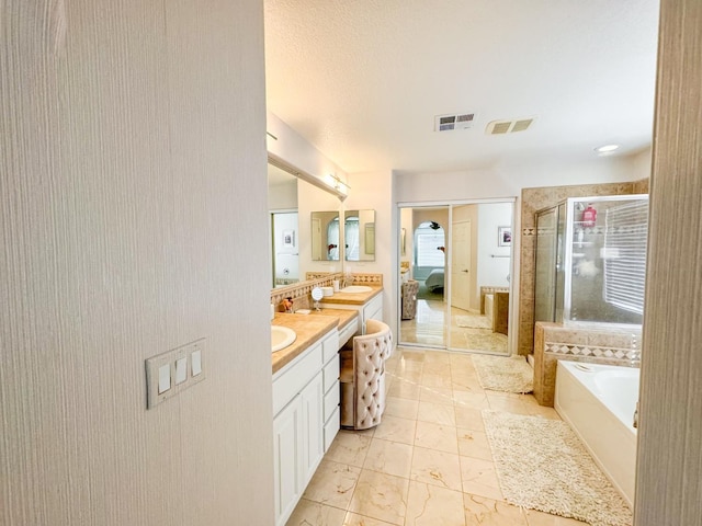 9130 Hunters Creek Way, Chowchilla, CA 93610 - bathroom with a stall shower, vanity, and a garden tub