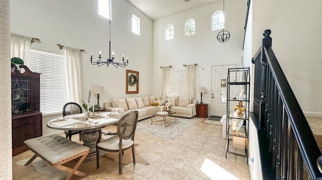 9130 Hunters Creek Way, Chowchilla, CA 93610 - dining area featuring a high ceiling, a chandelier, light tile patterned floors, and stairs