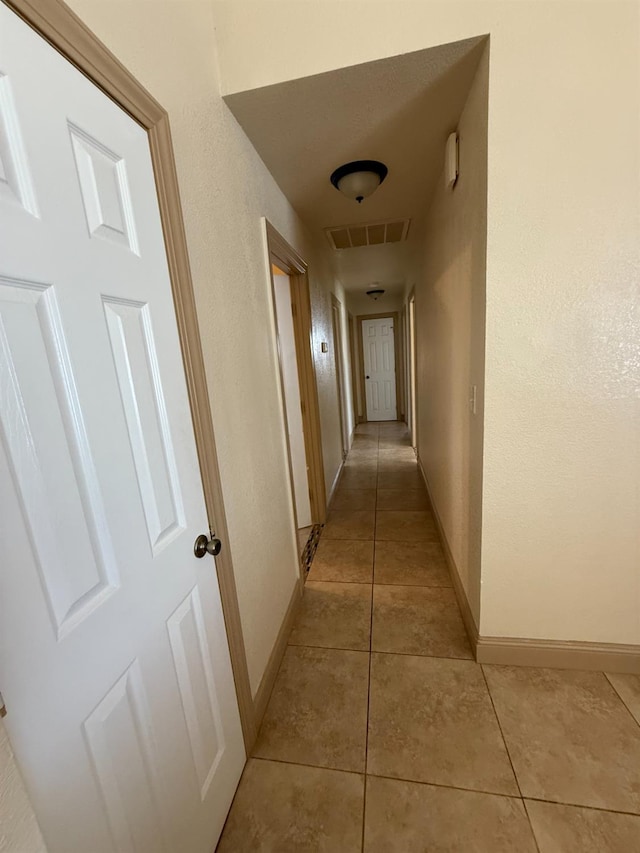 4352 W Los Altos, Fresno, CA 93722 - corridor with light tile patterned floors and baseboards