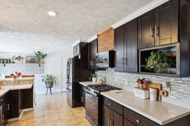 5554 E Montecito Ave, Fresno, CA 93727 - kitchen with gas range oven, freestanding refrigerator, backsplash, light countertops, and light tile patterned floors