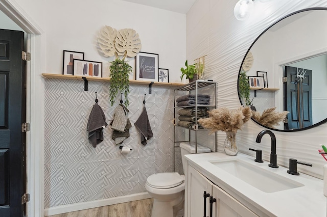 5554 E Montecito Ave, Fresno, CA 93727 - bathroom featuring vanity, toilet, and wood finished floors