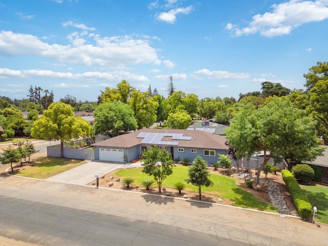5554 E Montecito Ave, Fresno, CA 93727 - ranch-style house featuring a front lawn, driveway, solar panels, and an attached garage