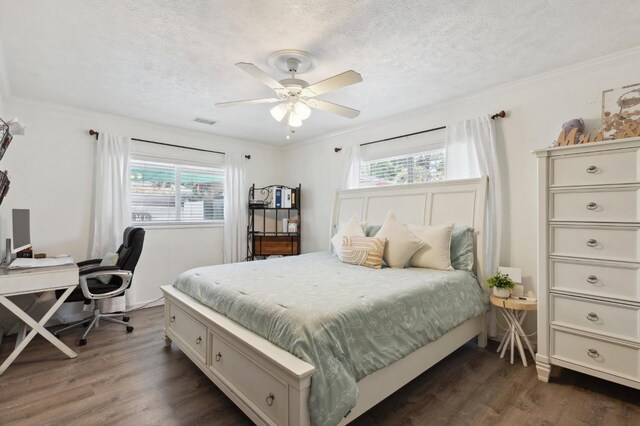 5554 E Montecito Ave, Fresno, CA 93727 - bedroom with dark wood-type flooring, a textured ceiling, an office area, ornamental molding, and ceiling fan