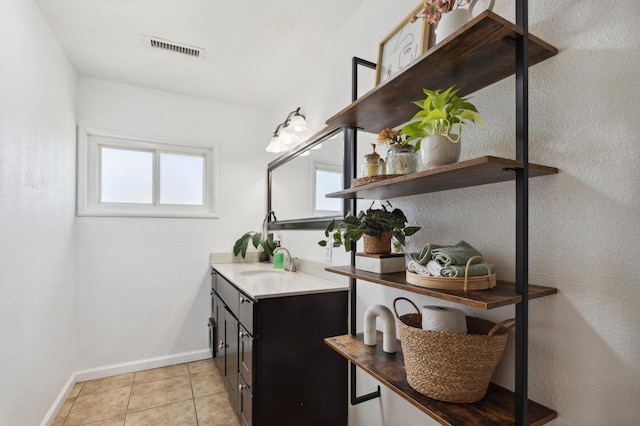 5554 E Montecito Ave, Fresno, CA 93727 - bathroom featuring vanity, baseboards, healthy amount of natural light, and tile patterned flooring