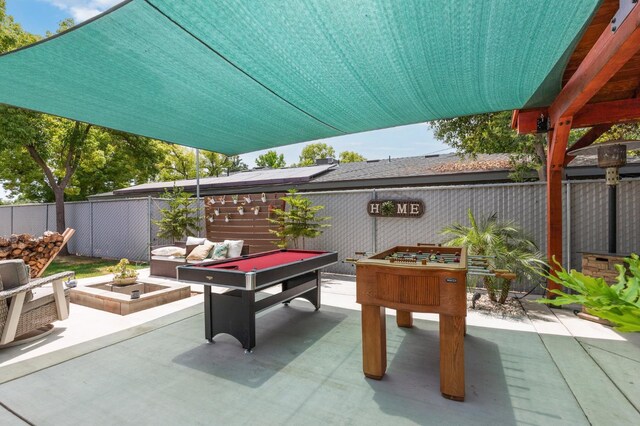 5554 E Montecito Ave, Fresno, CA 93727 - fenced backyard with a patio and an outdoor living space with a fire pit
