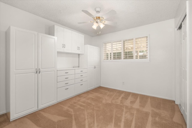 4705 N Holt Ave, Fresno, CA 93705 - unfurnished bedroom featuring light colored carpet, a textured ceiling, a closet, baseboards, and ceiling fan