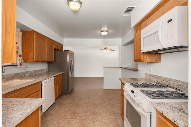 4705 N Holt Ave, Fresno, CA 93705 - kitchen featuring white appliances, a sink, ceiling fan, and brown cabinetry