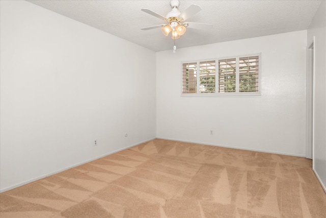 4705 N Holt Ave, Fresno, CA 93705 - empty room with light colored carpet, ceiling fan, a textured ceiling, and baseboards