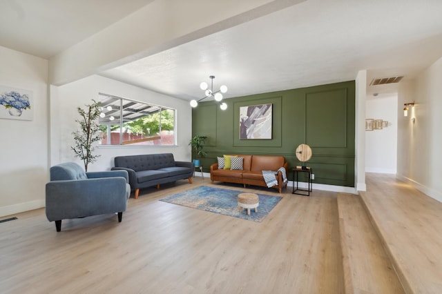 4489 N Chestnut Ave, Fresno, CA 93726 - living area with light wood-type flooring, a chandelier, and baseboards