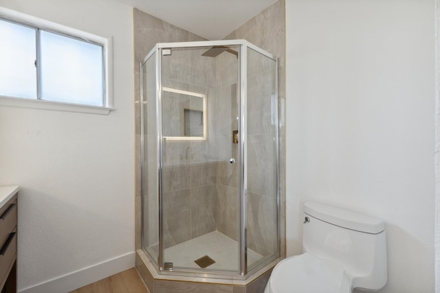 4489 N Chestnut Ave, Fresno, CA 93726 - bathroom with toilet, vanity, a shower stall, and baseboards