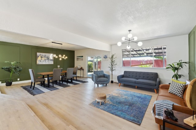 4489 N Chestnut Ave, Fresno, CA 93726 - living area with a chandelier, wood finished floors, baseboards, and a textured ceiling