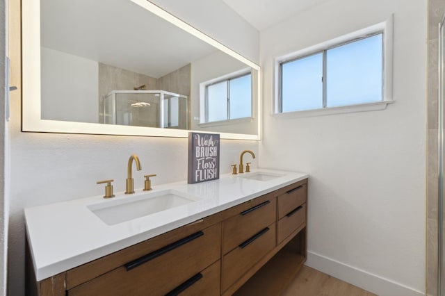 4489 N Chestnut Ave, Fresno, CA 93726 - full bath with double vanity, a stall shower, wood finished floors, and baseboards