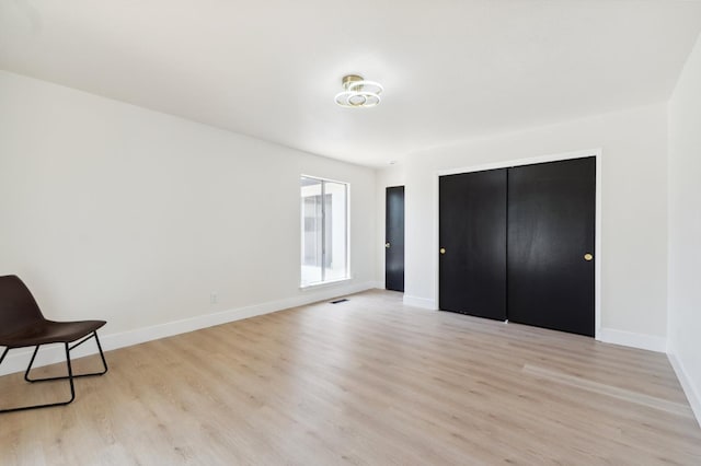 4489 N Chestnut Ave, Fresno, CA 93726 - unfurnished bedroom featuring light wood-style floors, baseboards, and a closet