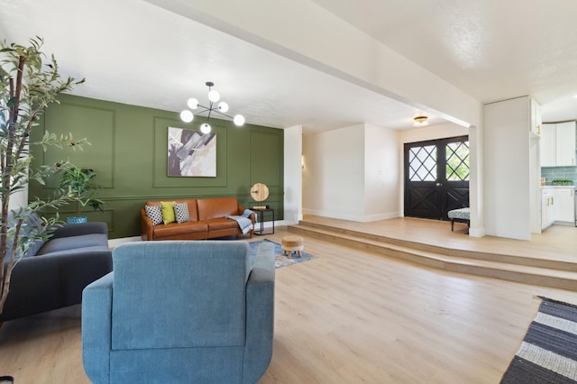 4489 N Chestnut Ave, Fresno, CA 93726 - living room with light wood-style floors, french doors, and baseboards