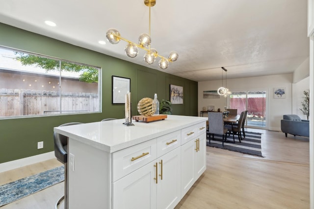 4489 N Chestnut Ave, Fresno, CA 93726 - kitchen featuring a chandelier, light wood-style floors, white cabinets, light countertops, and recessed lighting
