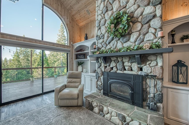 41905 Granite Ridge Rd, Shaver Lake, CA 93664 - living area with wooden ceiling, high vaulted ceiling, wood finished floors, a fireplace, and wooden walls