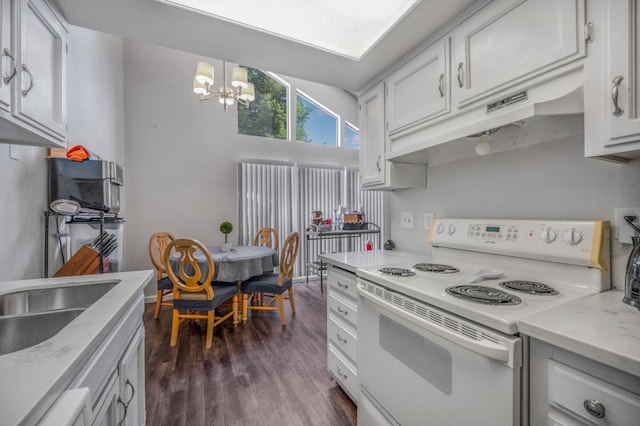 5965 E Shields Ave Unit 131, Fresno, CA 93727 - kitchen with white range with electric cooktop, a chandelier, under cabinet range hood, light countertops, and dark wood-style floors