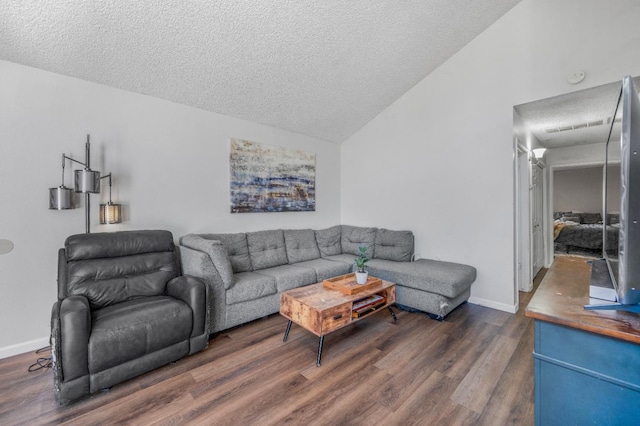5965 E Shields Ave Unit 131, Fresno, CA 93727 - living area featuring lofted ceiling, wood finished floors, a textured ceiling, and baseboards