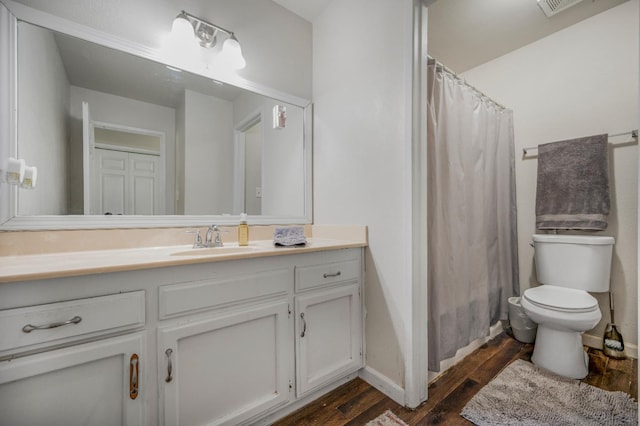 5965 E Shields Ave Unit 131, Fresno, CA 93727 - bathroom with wood finished floors, vanity, toilet, baseboards, and curtained shower