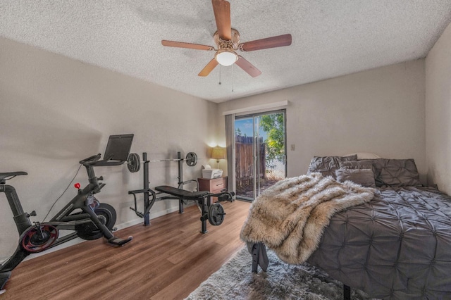 5965 E Shields Ave Unit 131, Fresno, CA 93727 - bedroom featuring access to outside, wood finished floors, a textured ceiling, ceiling fan, and baseboards