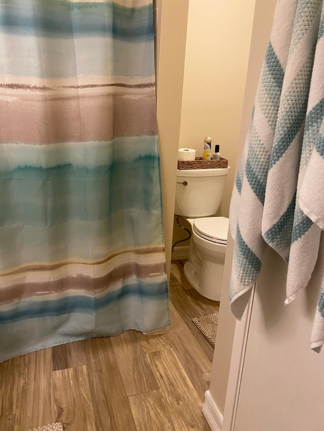 5815 E Lansing Way, Fresno, CA 93727 - full bath featuring toilet, wood finished floors, and a shower with shower curtain