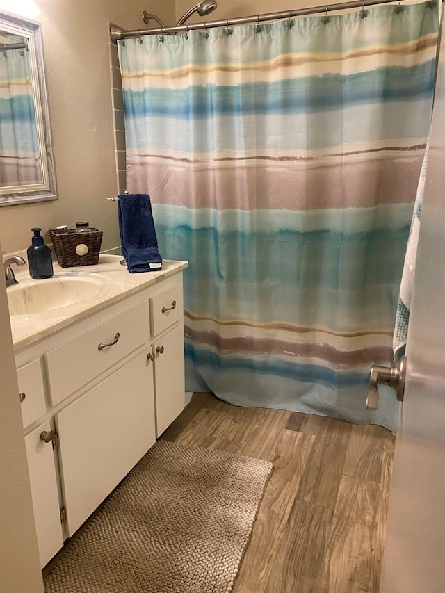5815 E Lansing Way, Fresno, CA 93727 - full bathroom with vanity, wood finished floors, and curtained shower