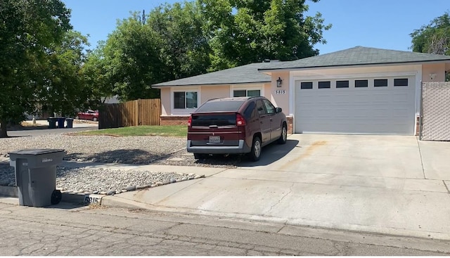 5815 E Lansing Way, Fresno, CA 93727 - ranch-style house with driveway, an attached garage, and stucco siding